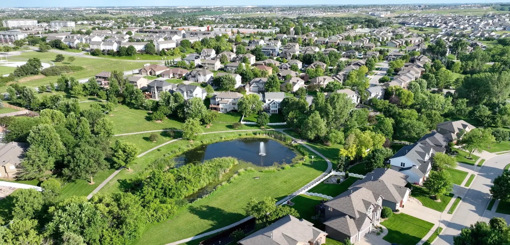 Aerial view of the Falcon Ridge neighborhood, its park, and central pond with fountain